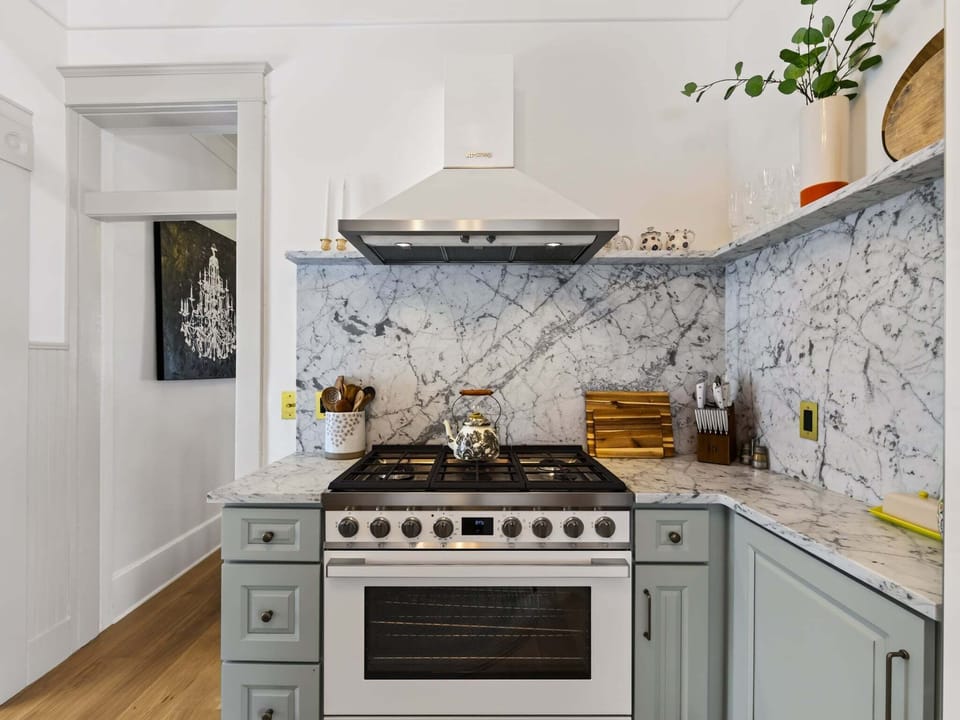A chef's dream with modern appliances and elegant finishes designed for both functionality and style. The kitchen seamlessly connects to dining and living spaces, creating an open concept perfect for gathering. Spacious countertops provide ample preparation space, while quality cabinetry and fixtures offer convenience.