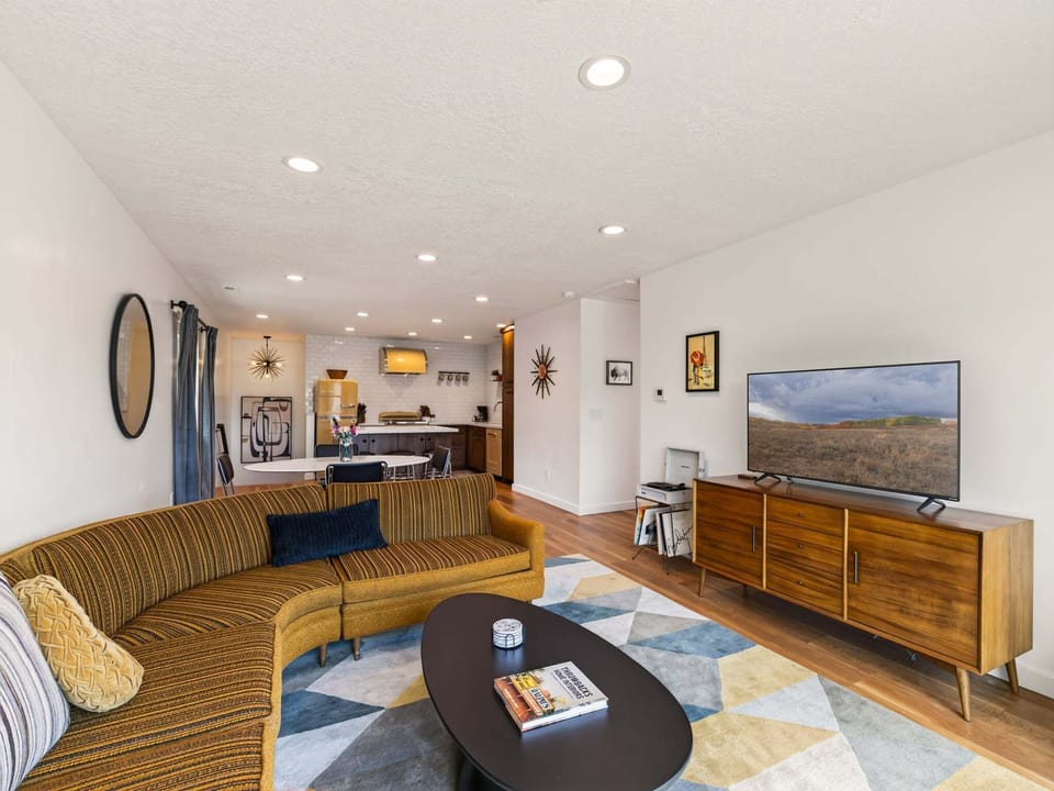Step into a stylish retro retreat, where vintage charm meets modern comfort with bold colors, cozy seating, and timeless design.