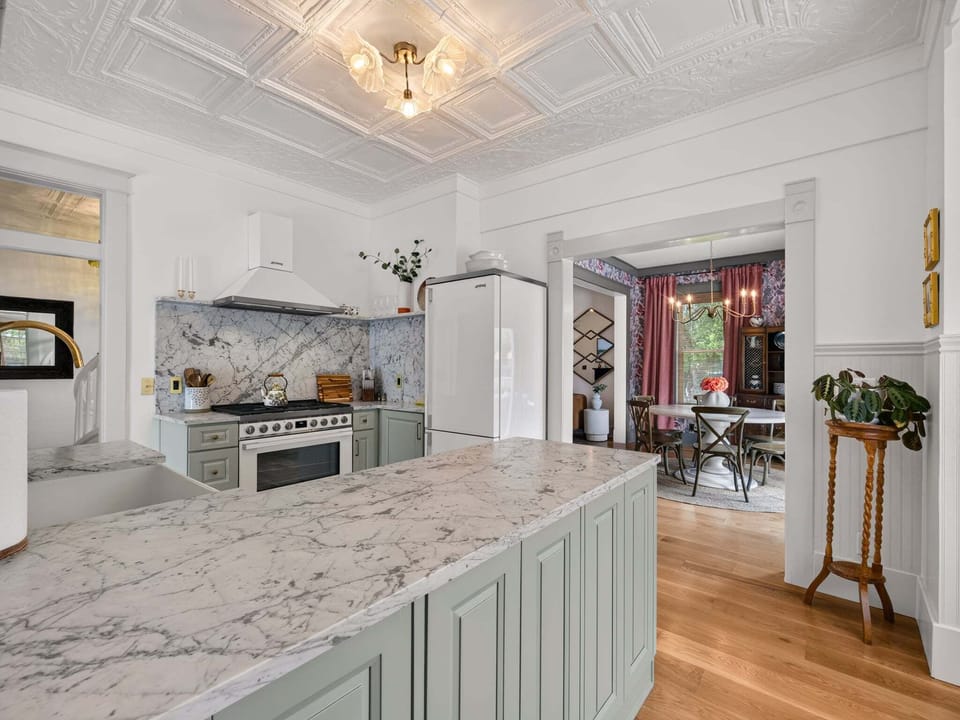 A chef's dream with modern appliances and elegant finishes designed for both functionality and style. The kitchen seamlessly connects to dining and living spaces, creating an open concept perfect for gathering. Spacious countertops provide ample preparation space, while quality cabinetry and fixtures offer convenience.