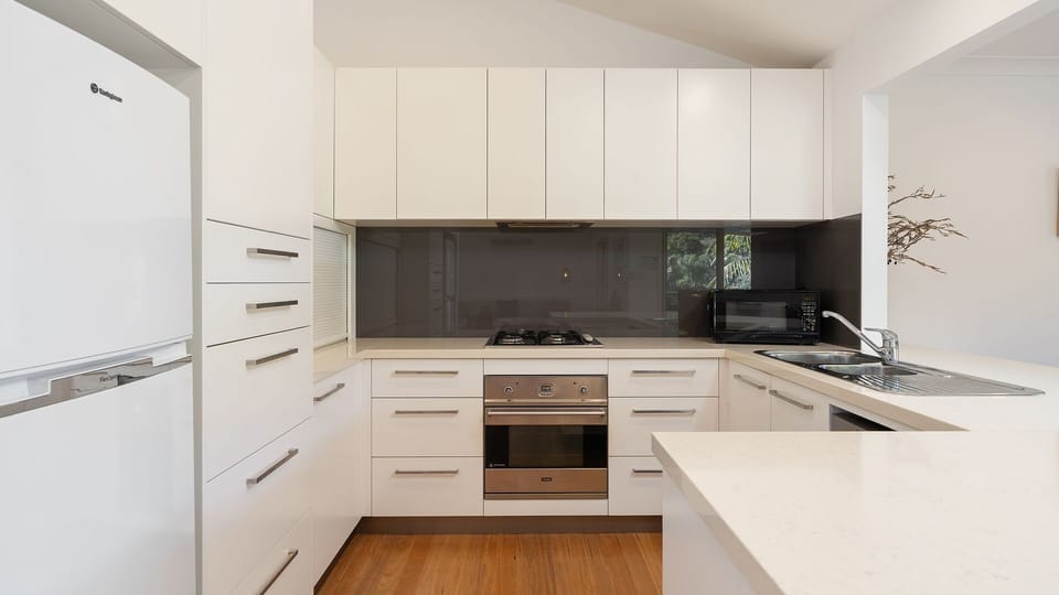 Modern, fully equipped kitchen with generous bench space