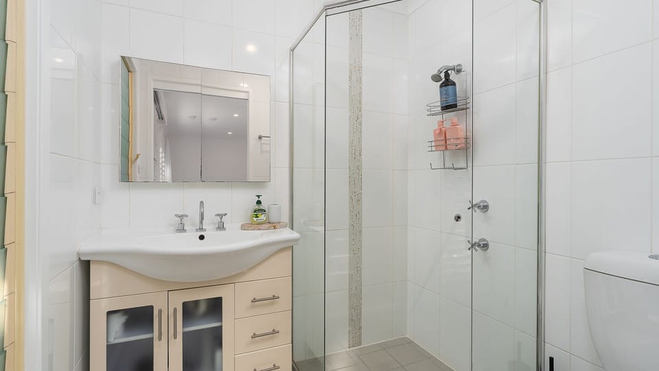 Convenient bathroom with walk-in shower and modern vanity