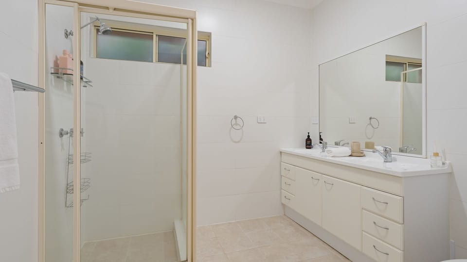 Bright bathroom with walk-in shower and generous vanity space