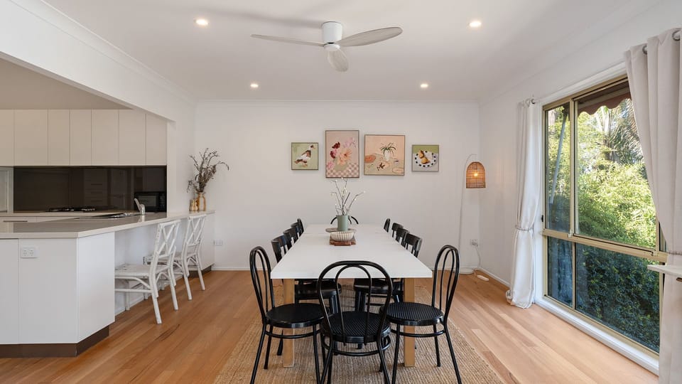 Bright dining space with leafy outlooks and room for everyone