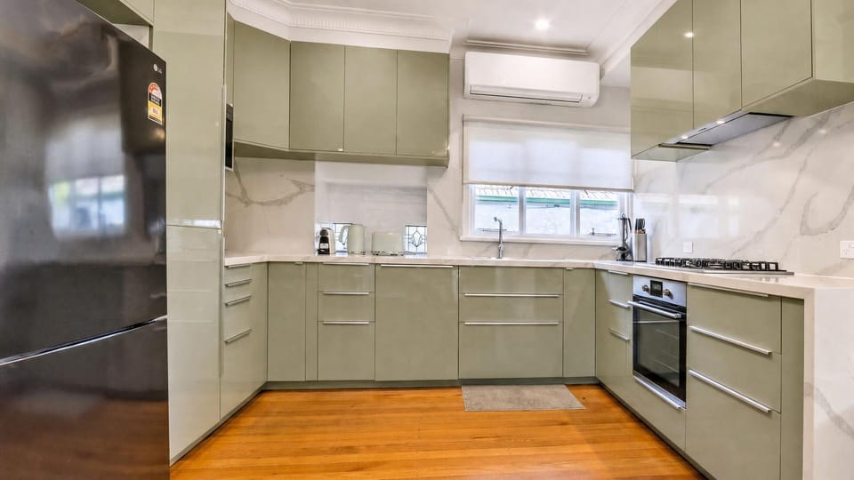 Fully equipped kitchen featuring sleek cabinetry and appliances.
