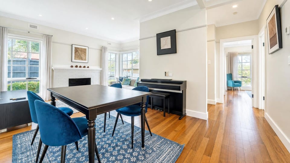 Open-plan dining and kitchen area with hardwood floors.