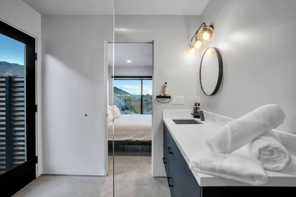 Primary suite minimalist designer bathroom with outdoor shower access