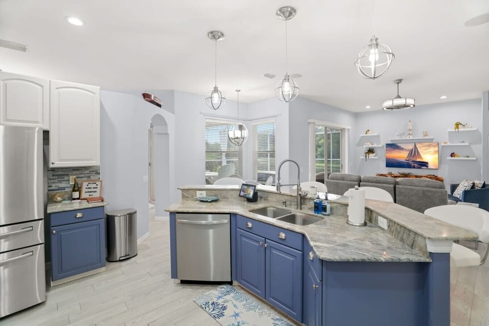 A fully equipped kitchen with sleek quartz counters and stainless steel appliances, ready for home-cooked meals.