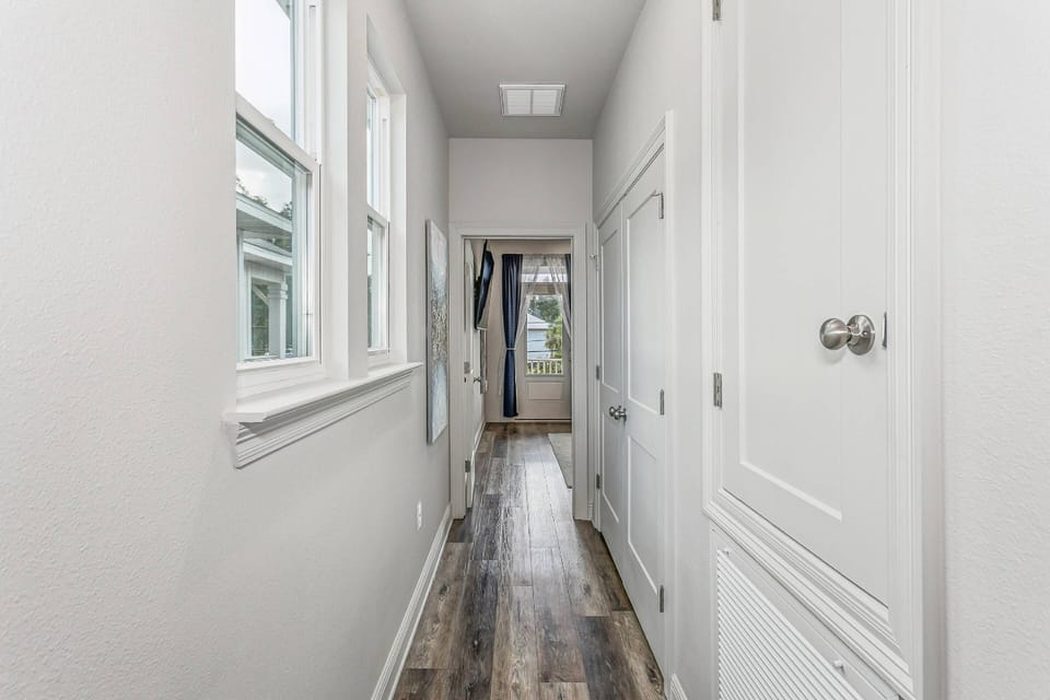 The two upstairs bedrooms are separated with a long hallway and laundry closet