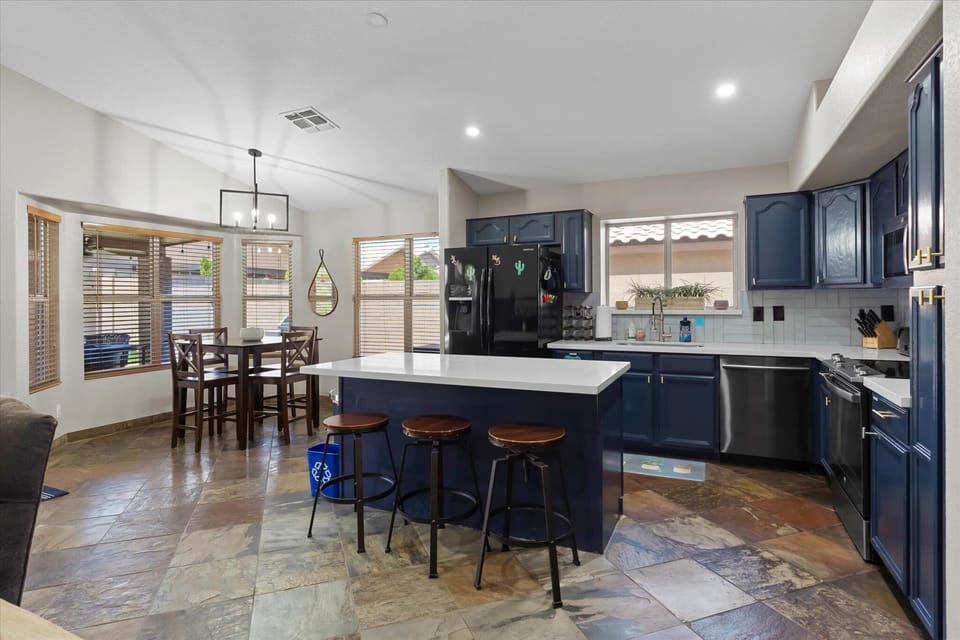 Open kitchen and dining layout keeps everyone connected, with island seating and multiple dining spaces.