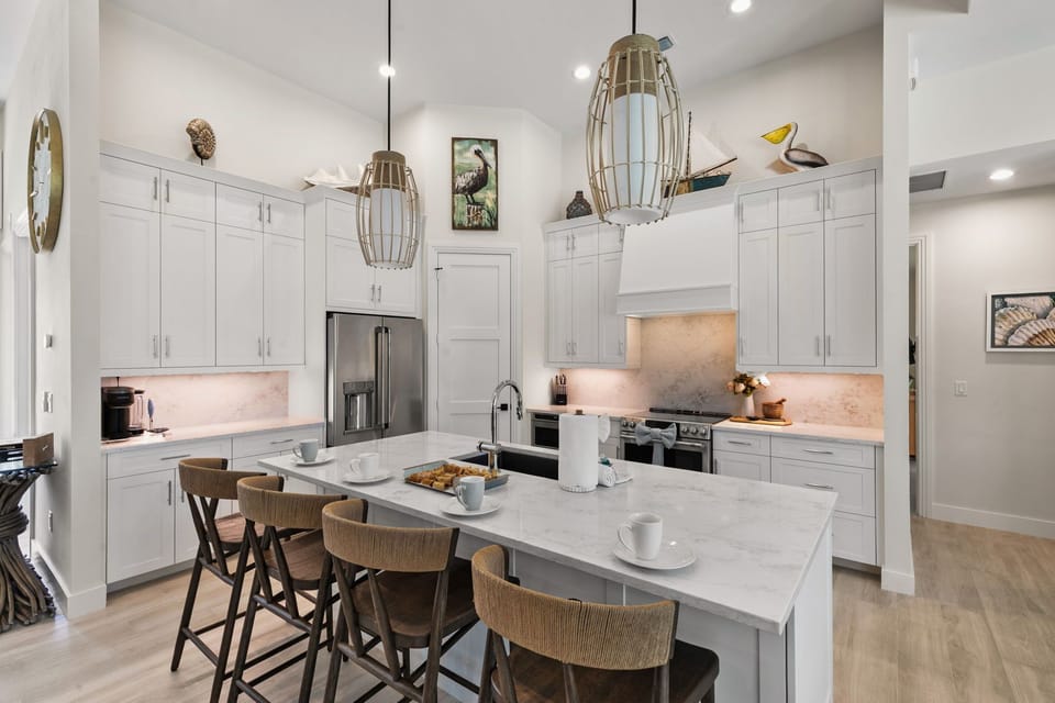 Step into your bright, airy kitchen with gleaming marble countertops, modern appliances, and a welcoming island perfect for morning coffee or gathering with loved ones.
