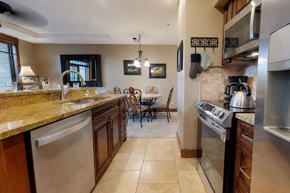 Step into your fully-equipped kitchen with gleaming granite counters, stainless appliances, and everything you need to cook like you're home—plus a welcoming dining area for gathering over meals.