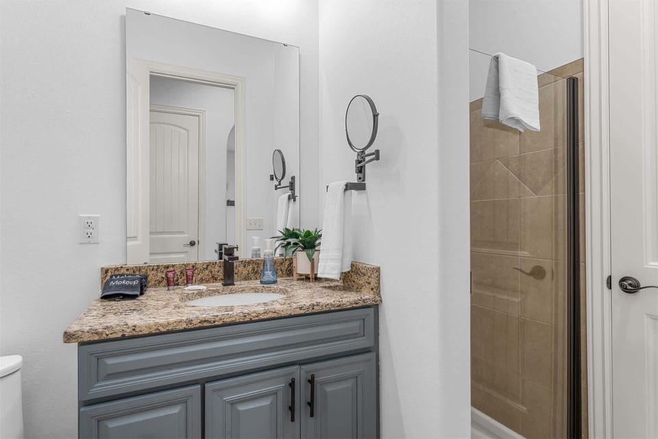 A single vanity & glass shower await in this ensuite​