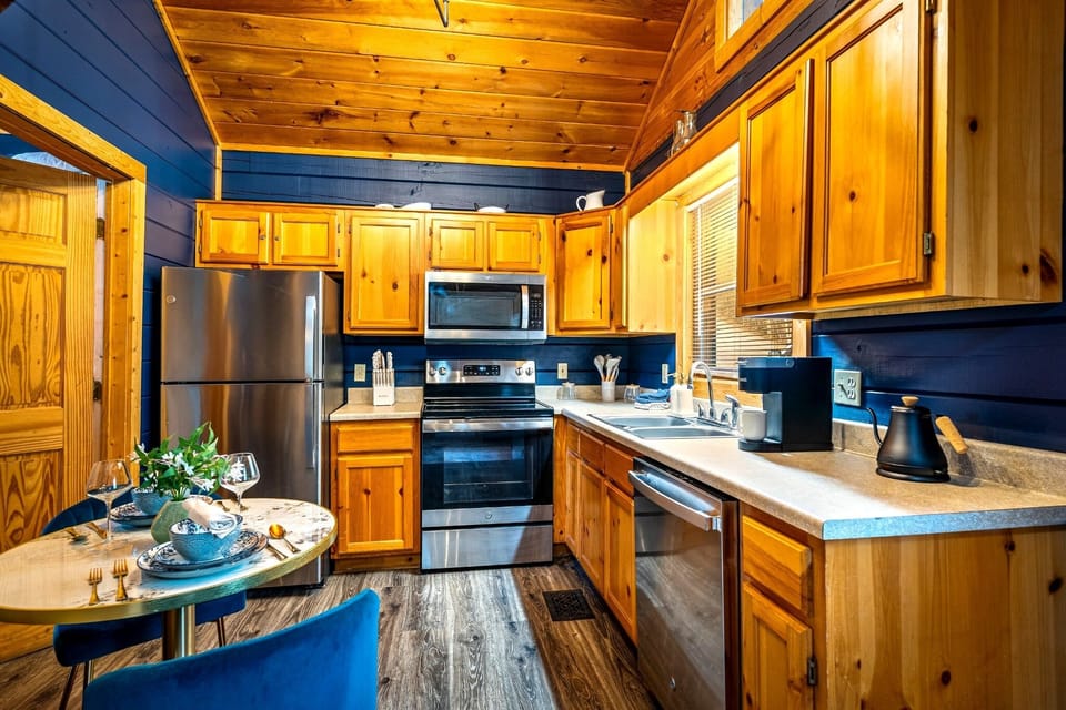 A warm, fully equipped kitchen with modern appliances and everything you need for a cozy night in. Enjoy a beautifully set dining table for two, perfect for morning coffee or a relaxed dinner after a day exploring the mountains.