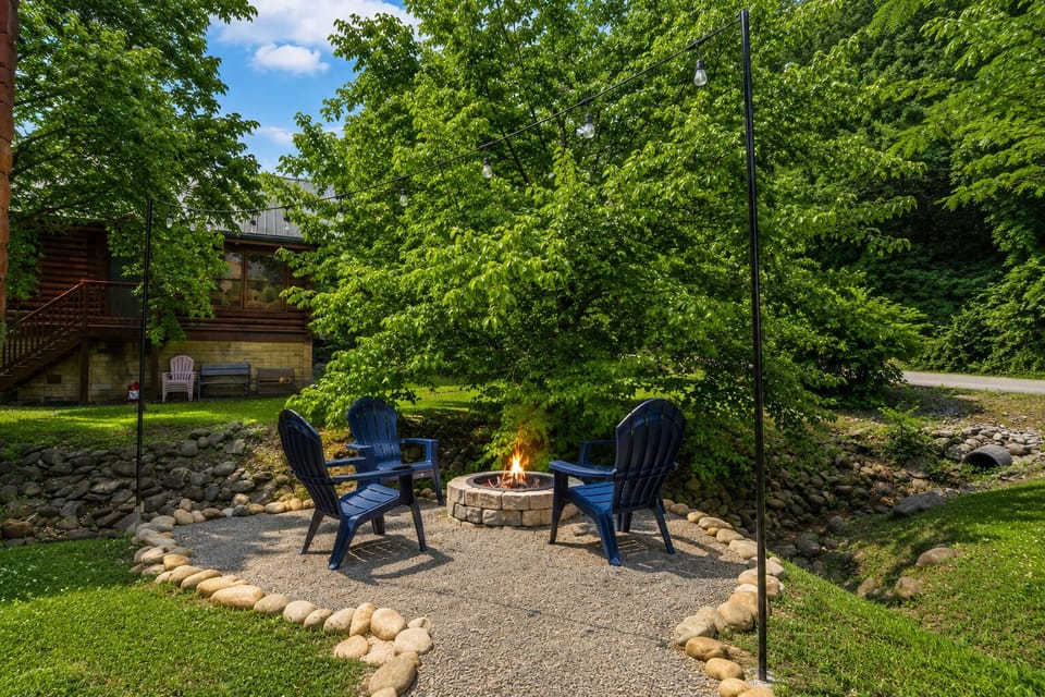 Gather around the fire pit beside a peaceful creek and enjoy your own private outdoor retreat. Surrounded by trees and tucked behind the cabin, this cozy space offers the perfect setting for a relaxing night.