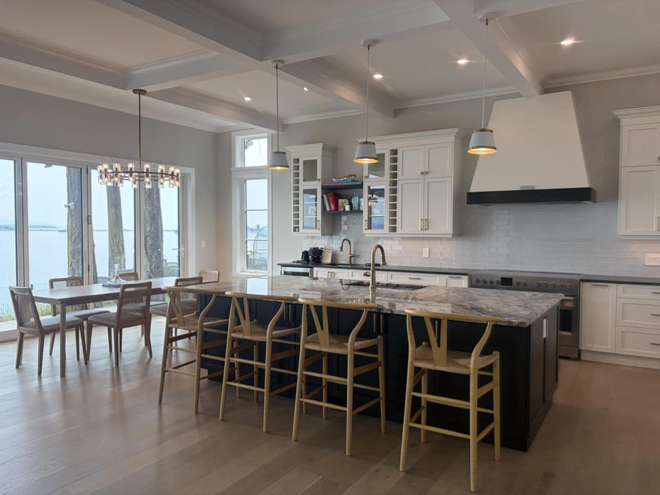 Chef’s dream kitchen featuring a massive dark island with luxury marble countertops.