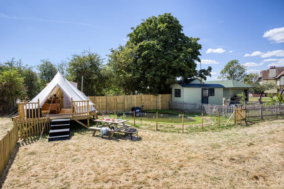 A soothing pond separates Cosy Conkers from its little sister bell tent Conkers & Canvas