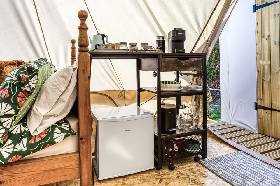 Compact kitchen with the essentials, a fridge, kettle, coffee machine, and most importantly for hot chocolates by the fire, a milk frother!
