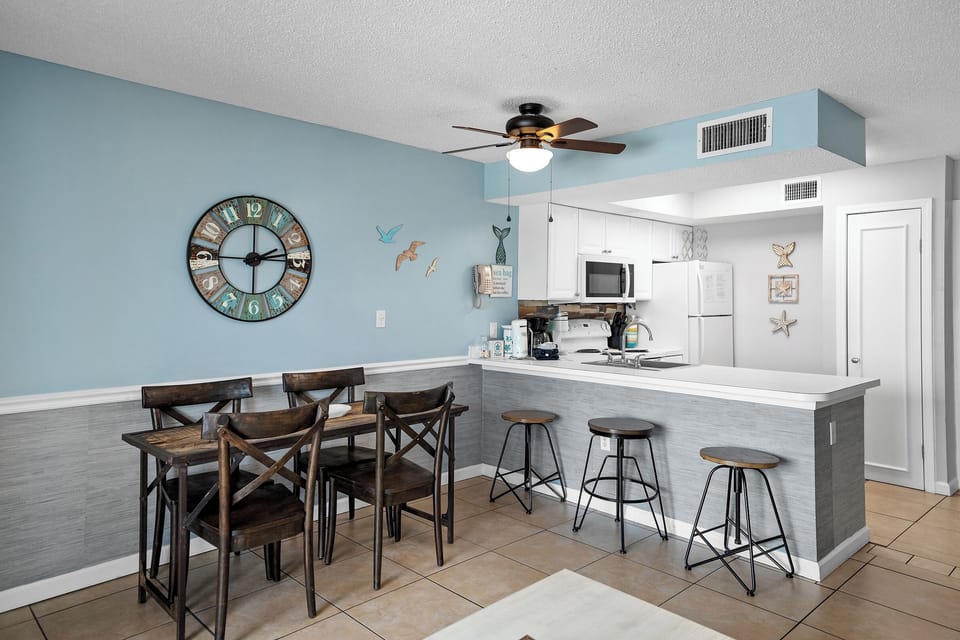 Dining table seats 4, plus breakfast bar seating for 3—plenty of room for meals together
