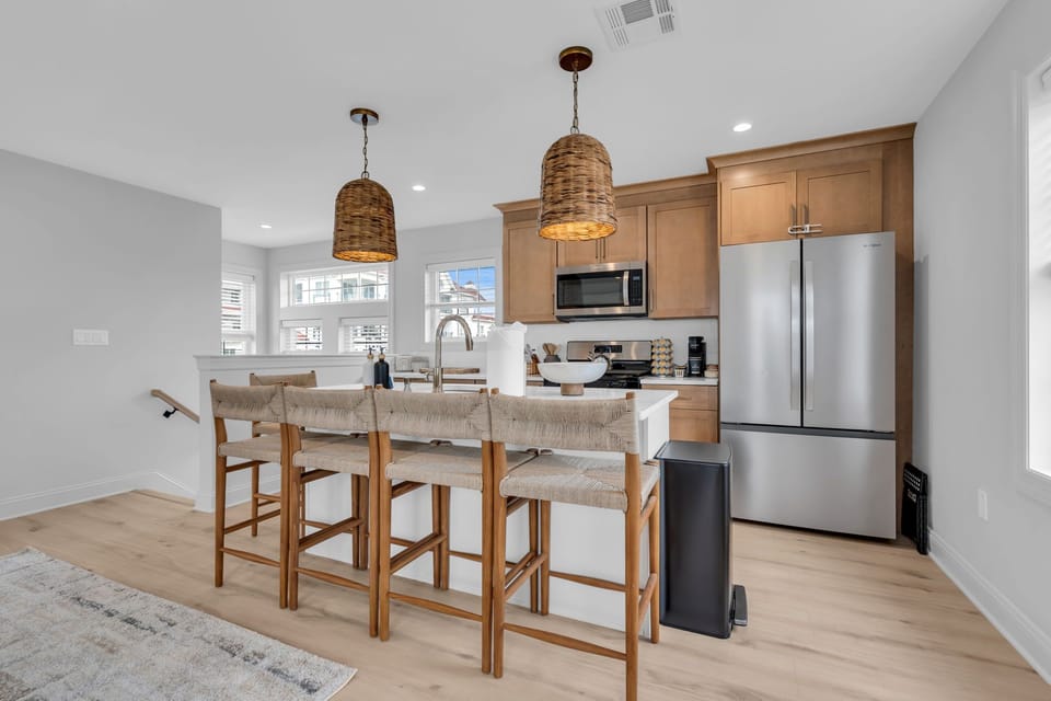 Bright modern kitchen with island seating for four and stainless appliances