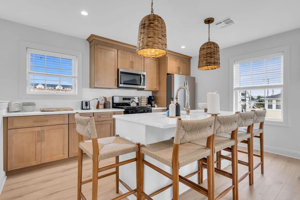 Bright modern kitchen with island seating for 5 and stylish coastal touches