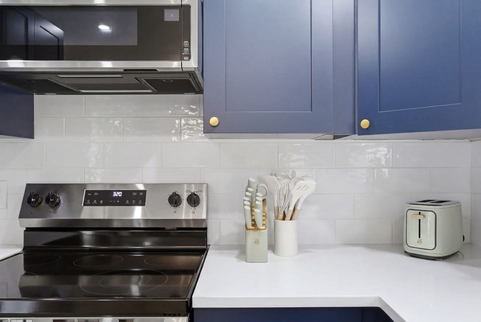 GE Electric Stove and Single Oven with Toaster, Blender, and Cooking Basics on hand. Plenty of counter space for prepping group meals.
