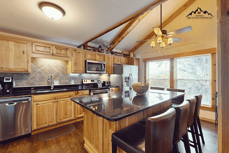 This bright kitchen is your home base for mountain mornings. Gleaming granite counters, stainless appliances, and plenty of prep space make cooking a pleasure, while the island invites you to gather with family and friends.