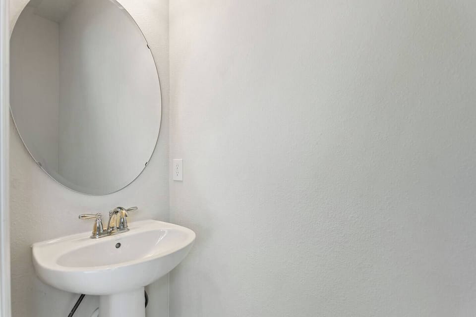 Convenient half bathroom located just off the pool area—perfect for quick access while swimming or relaxing outdoors without needing to go inside.