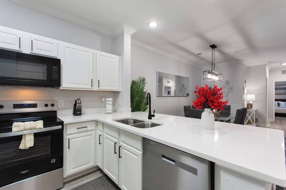 Fully equipped kitchen featuring a new dishwasher, microwave, oven, and double sinks. Designed for convenience, it has everything you need to cook, clean, and enjoy meals with ease.