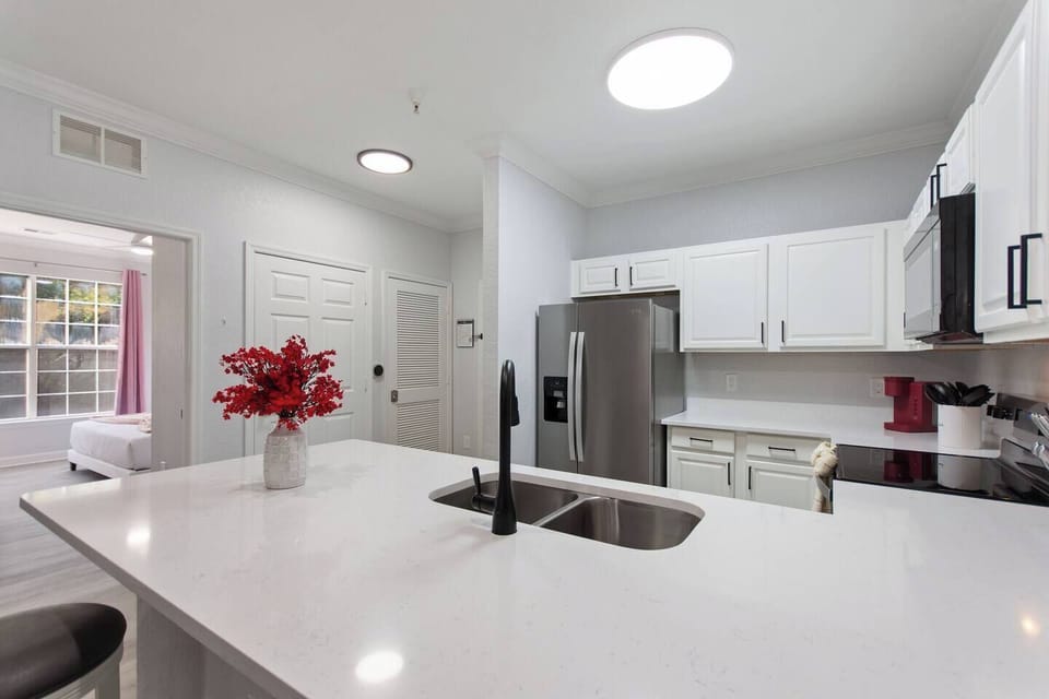 Modern kitchen island with sleek countertops and comfy bar stools—perfect for casual meals, morning coffee, or chatting while cooking. Stylish, functional, and designed for together time.