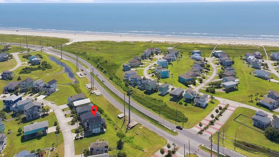 Aerial view of beachside home just steps from the sand and shoreline