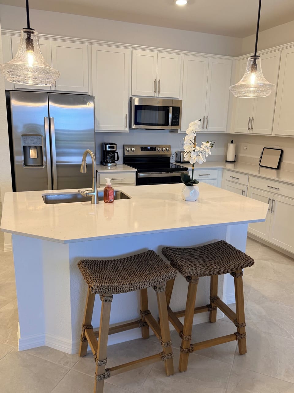     Fully equipped kitchen with quartz countertops, stainless-steel appliances. 