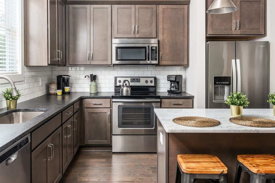 Full-size range, microwave, and rich cabinetry — everything you need to cook a real meal in, not just heat one up.