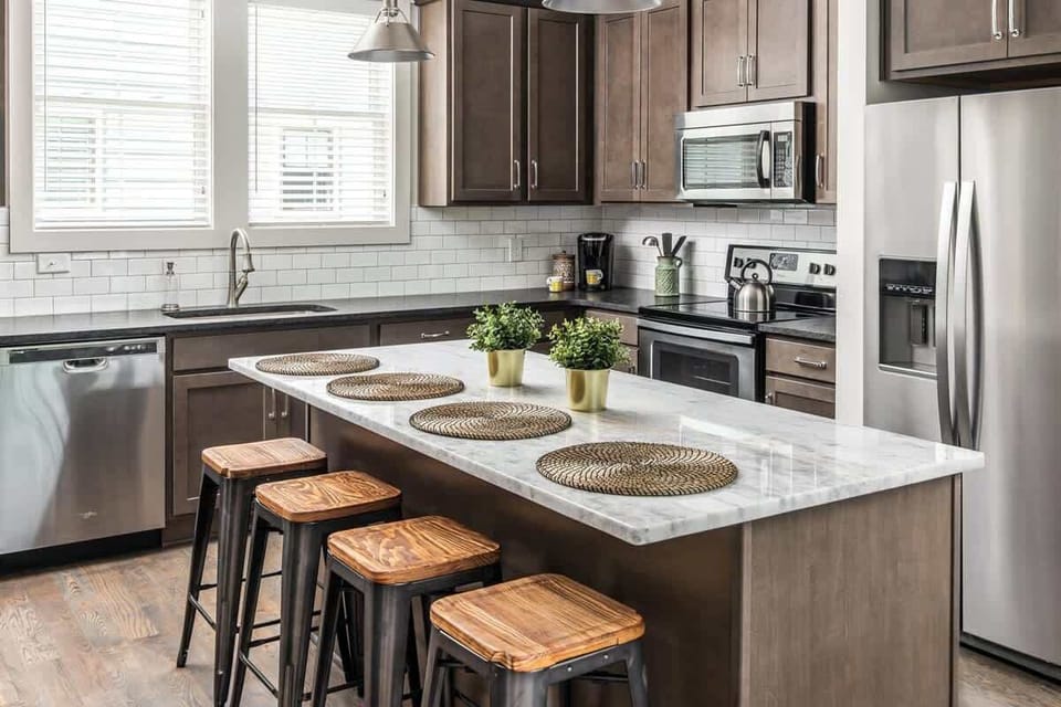 Fully stocked kitchen with bar seating for 4 — Keurig, drip coffee maker, blender, and toaster ready for your morning routine.