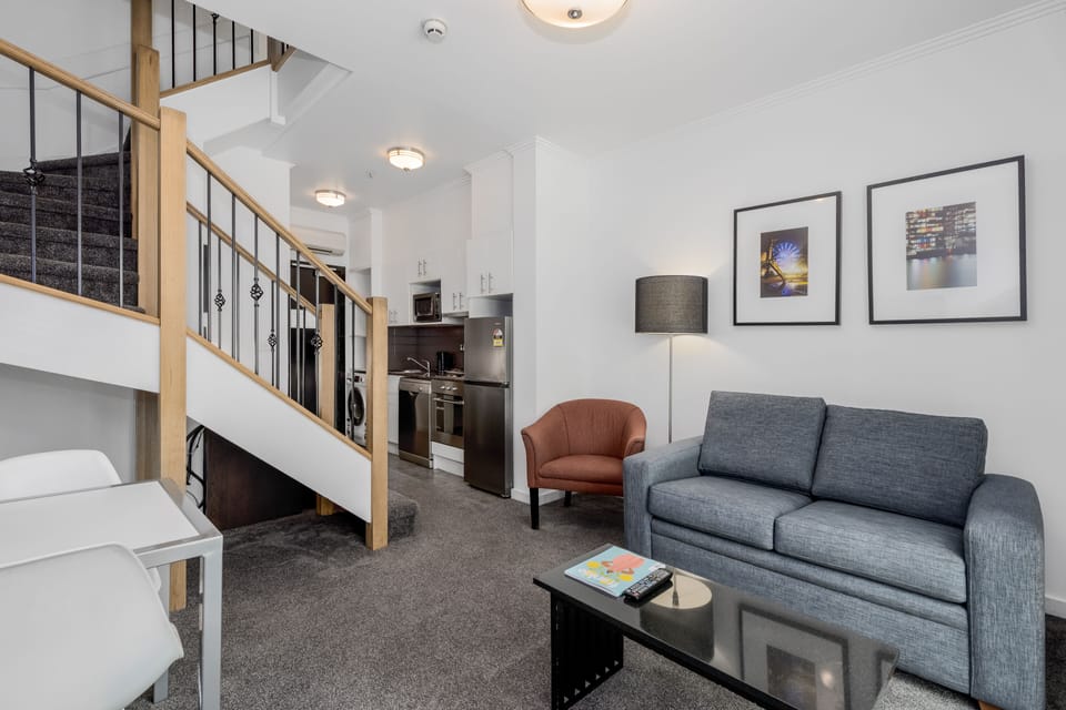 Deluxe Two Bedroom Apartment | Living area | 40-inch LED TV with cable channels, TV, iPod dock