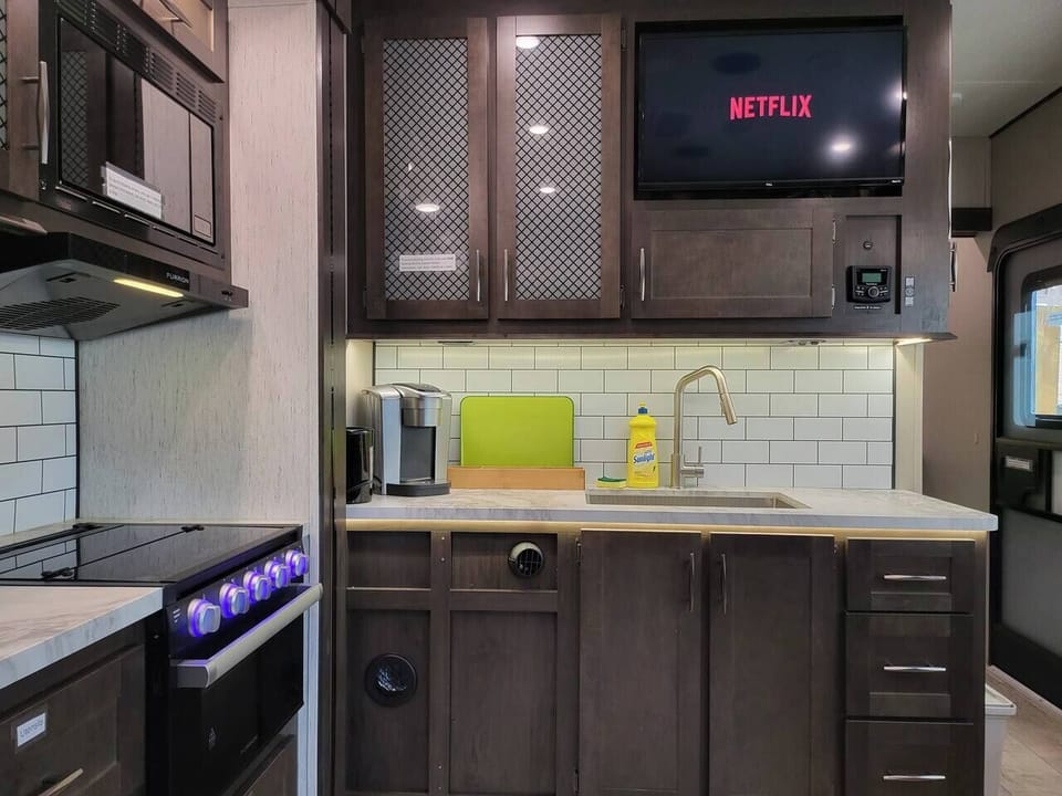Kitchen with coffee maker, sink, and mounted TV — Nordic Forest Spa
