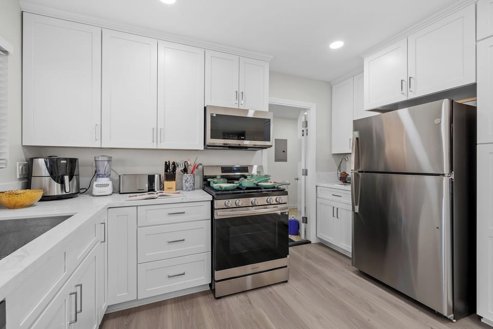 Fully equipped kitchen featuring stainless steel appliances and bright finishes.