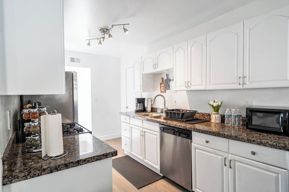 Step into a bright, modern kitchen designed for both comfort and functionality. This beautifully updated space features crisp white cabinetry, elegant granite countertops, and stainless-steel appliances that create a clean, upscale feel.