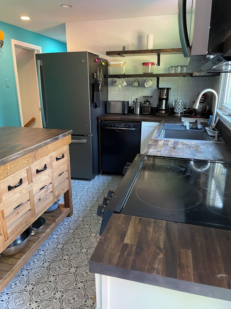 The kitchen stove, dishwasher, refrigerator, coffee and tea implements.