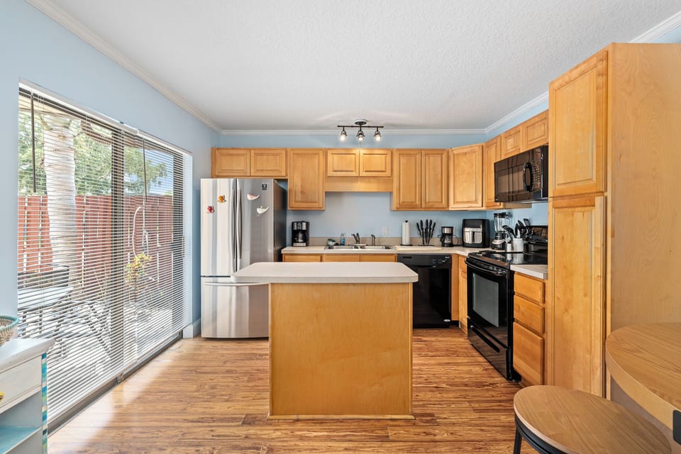 Kitchen showing island and sliding glass door leading to patio