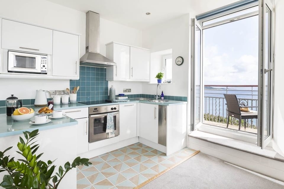 Kitchen opening onto the balcony at Epic View in Coverack