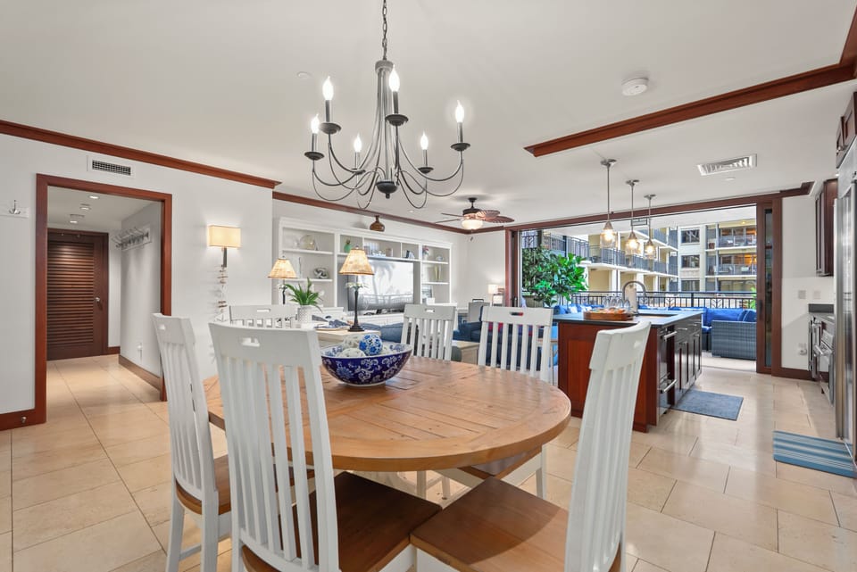 Gather six around the round table, the courtyard and palms filling the windows behind.