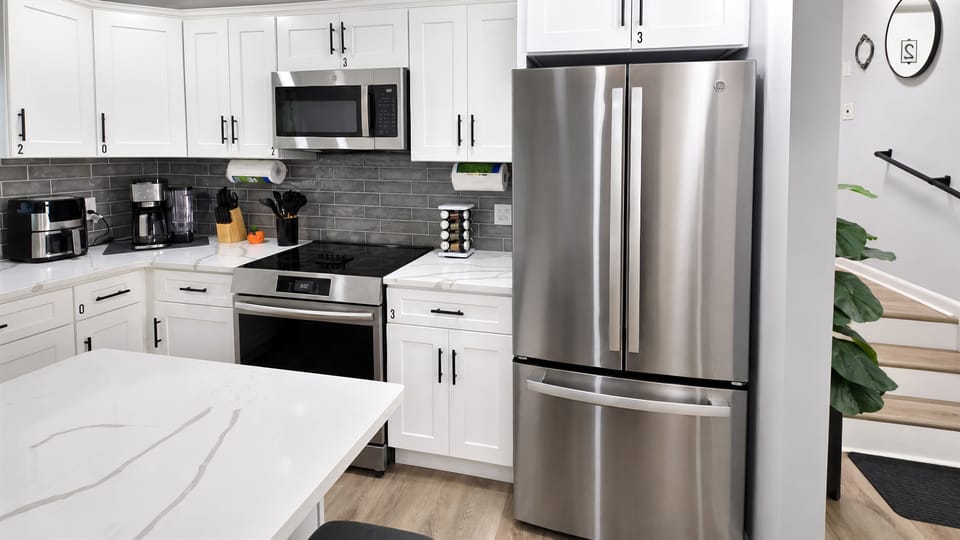 Kitchen with stainless-steel refrigerator