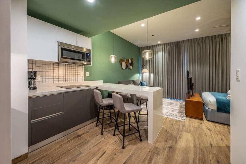Contemporary kitchen and dining area designed for convenience, whether you`re working remotely or enjoying a meal.