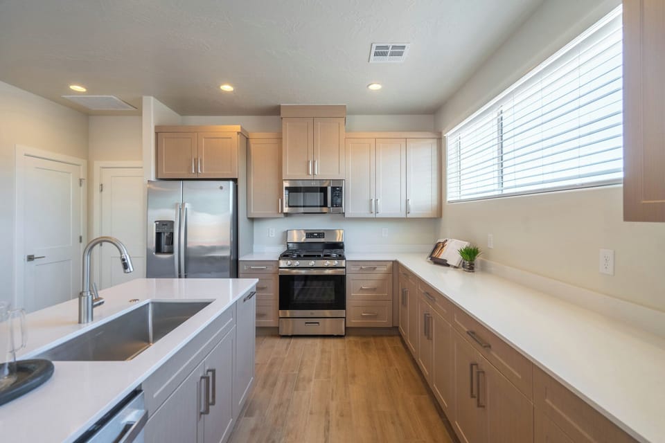 Kitchen is fully stocked with appliances and utensils 
