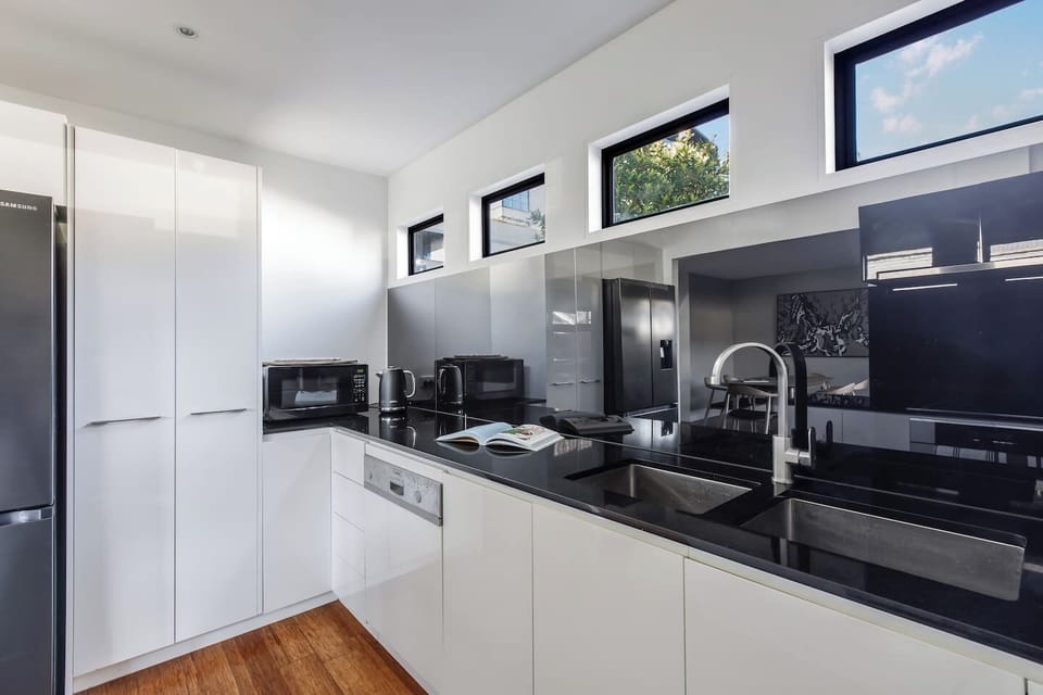 Channel your inner chef in the sleek, full-size kitchen with stone benchtops, a dishwasher, bread maker, espresso machine, and all the tools you’ll need.