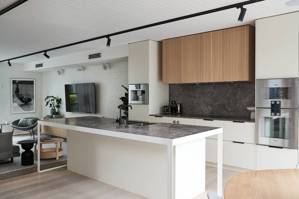 Gather around the expansive stone island, the perfect place to start your morning with coffee or settle in with a glass of wine while meals come together.