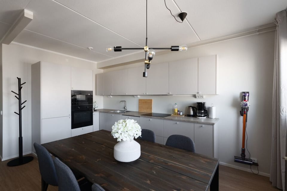 The living room and kitchen are one open space. Access to the downstairs balcony is from living room