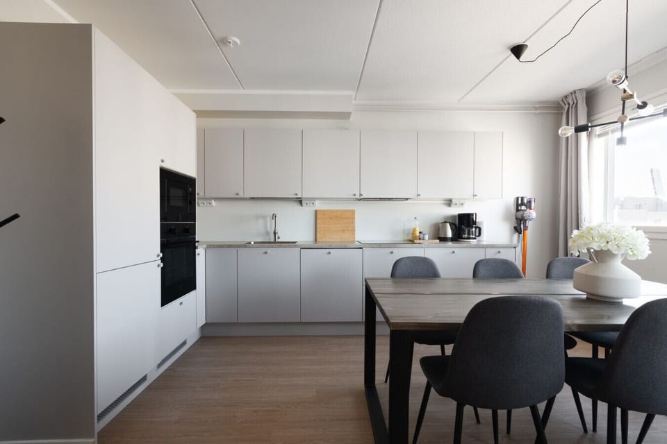 The living room and kitchen are one open space. Access to the downstairs balcony is from living room