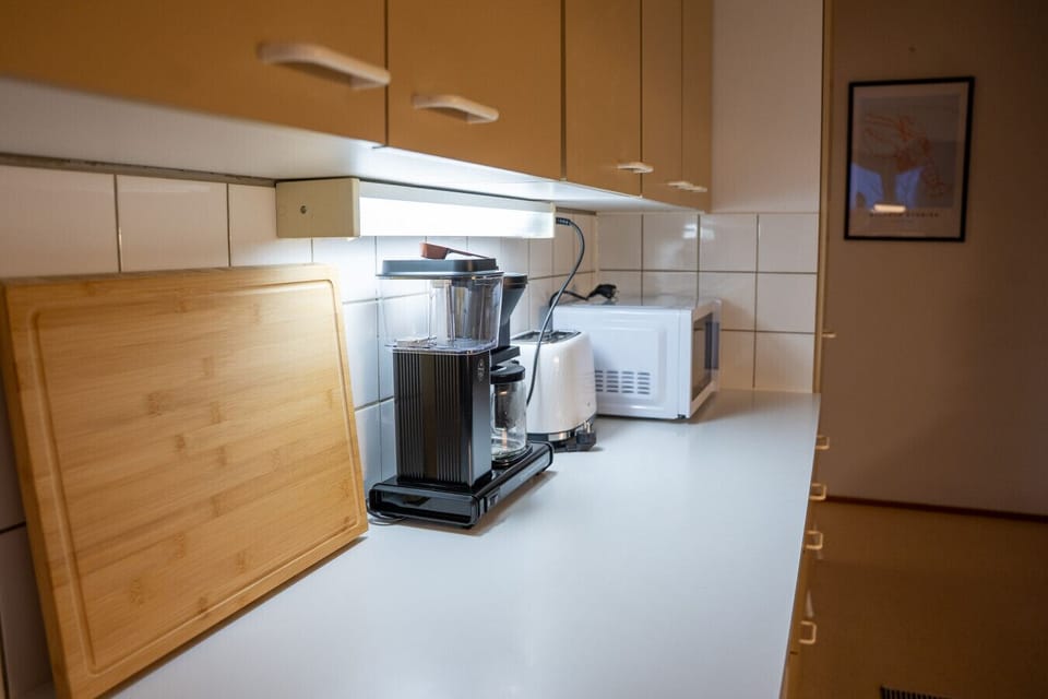 Kitchen has coffee machine, toaster and microwave