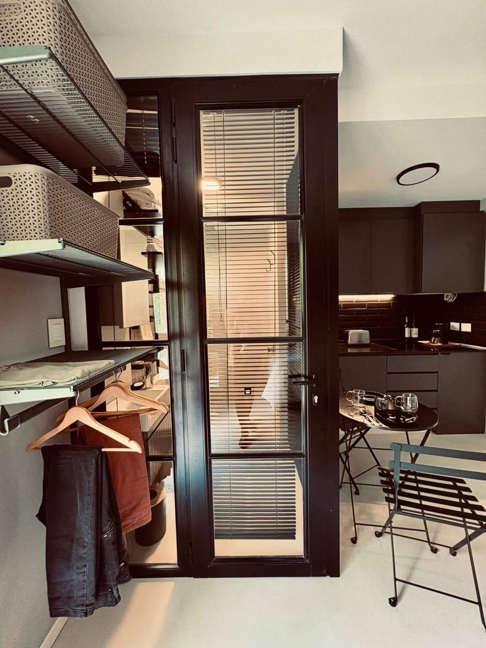 Open wardrobe near kitchenette